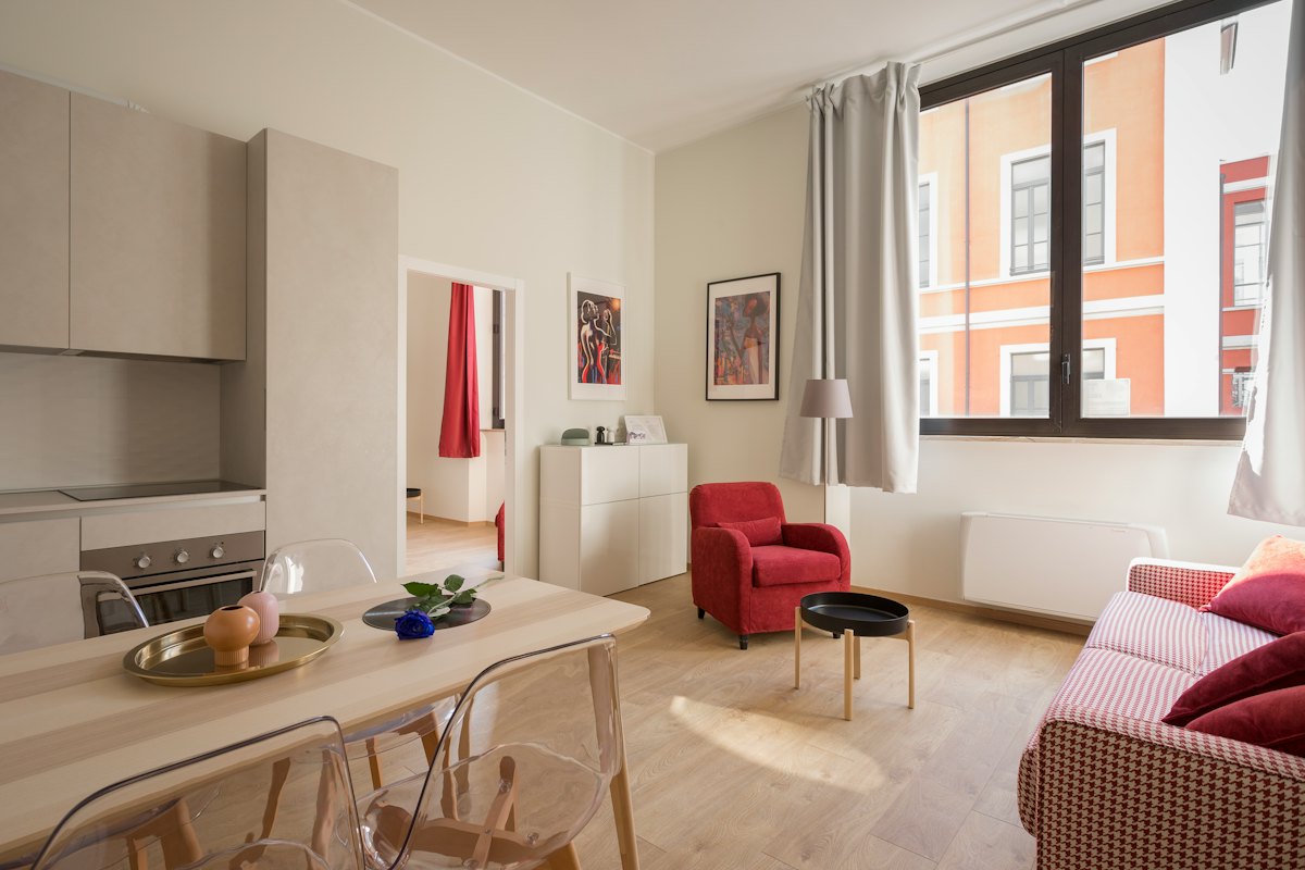 Bright rented apartment living room with red armchair
